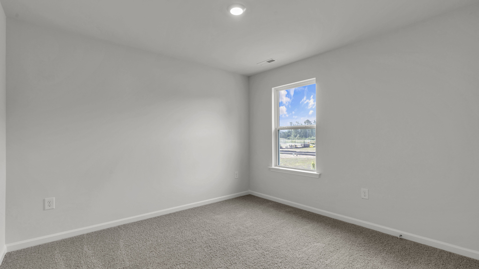 additional bedroom with window, carpeting, closet