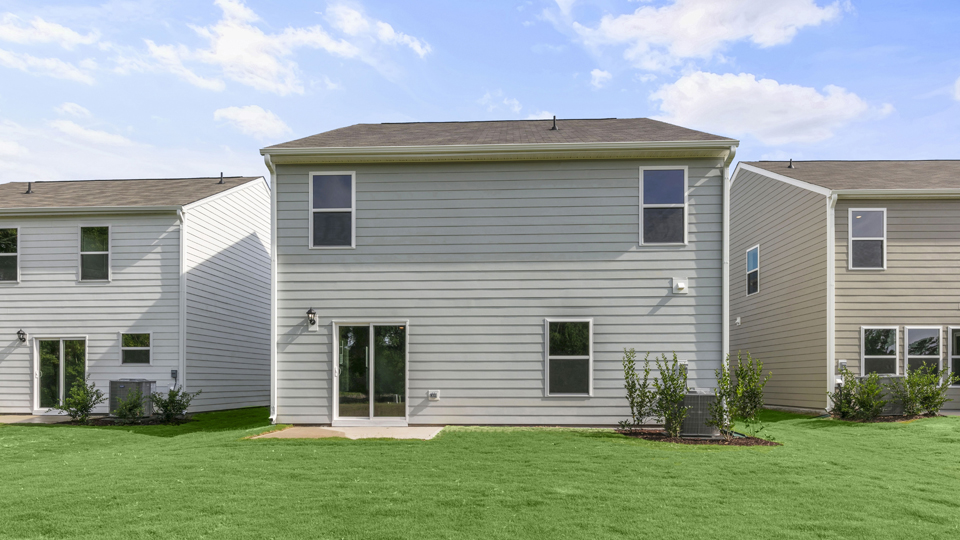 back exterior patio with concrete slab and open yard