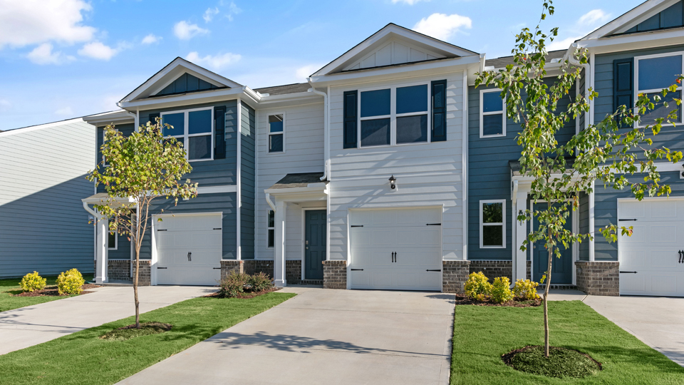 front exterior of pearson a2 with one car garage, white siding, dark blue accents