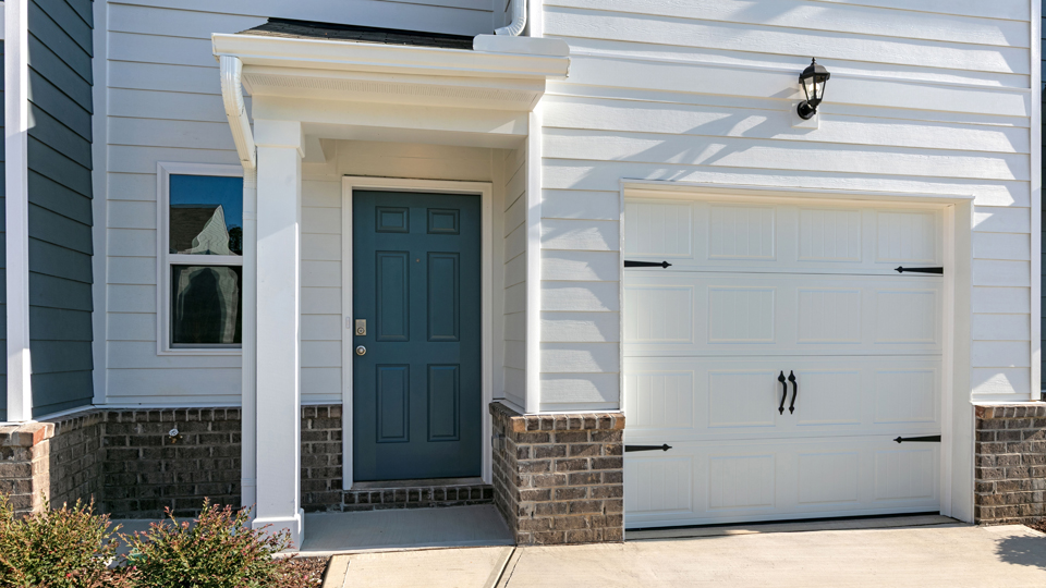 front door of pearson a2 floorplan with covered area and garage door