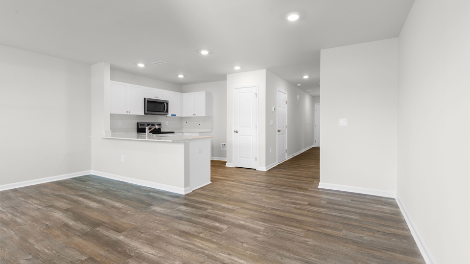 kitchen with quartz counters, kitchen island, pantry, stainless steel appliances