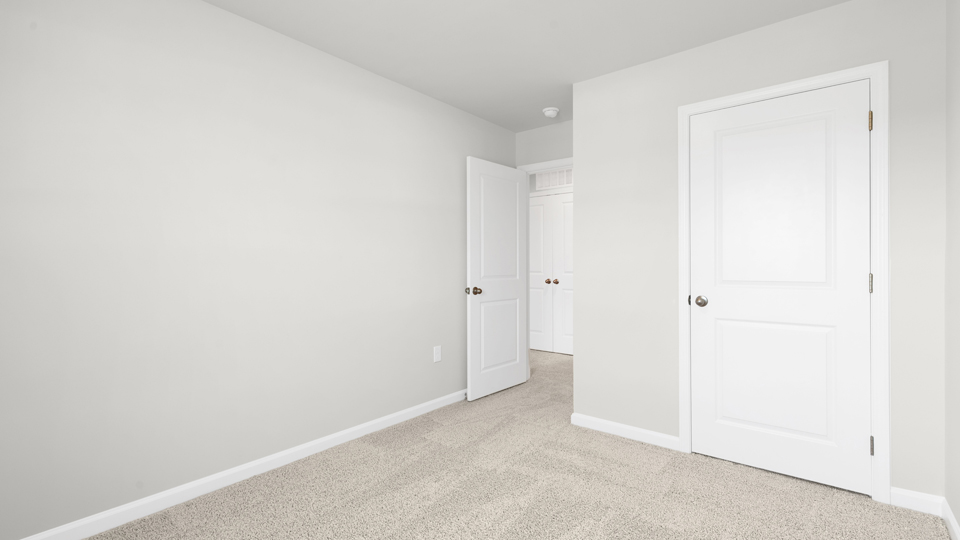 additional bedroom with window, carpeting, closet