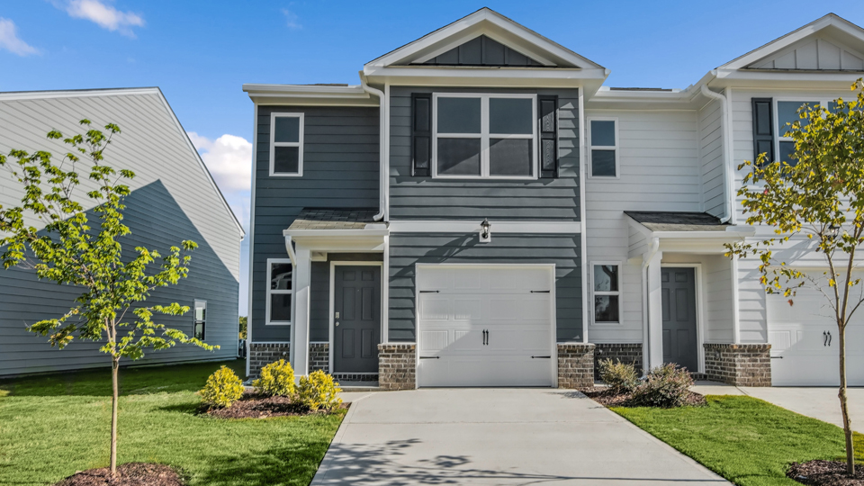 front exterior of Pearson floorplan, blue siding, dark blue shutters, one car garage with driveway