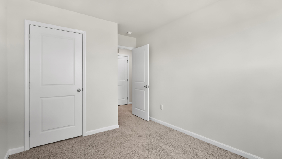 additional bedroom with window, carpeting, closet