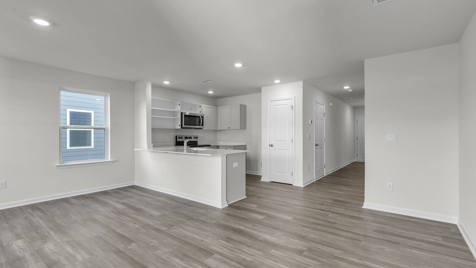 kitchen with quartz counters, kitchen island, pantry, stainless steel appliances