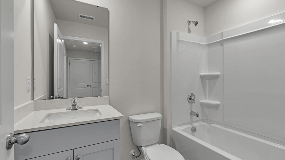 secondary bathroom with shower tub combo and single vanity sink