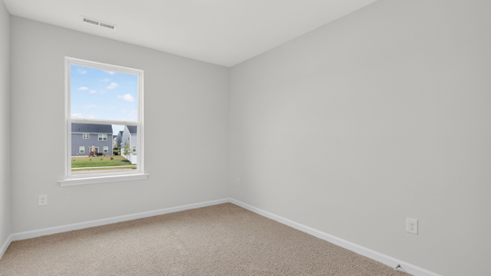 secondary bedroom with window and closet, carpeting