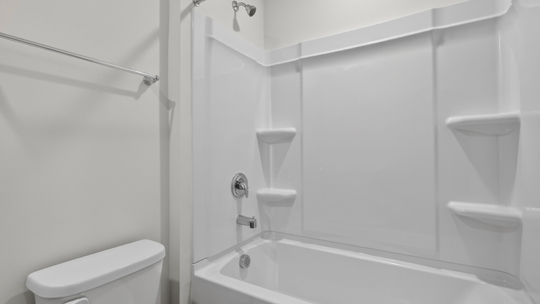 secondary bathroom with shower tub combo and single vanity sink