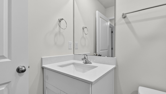 secondary bathroom with shower tub combo and single vanity sink