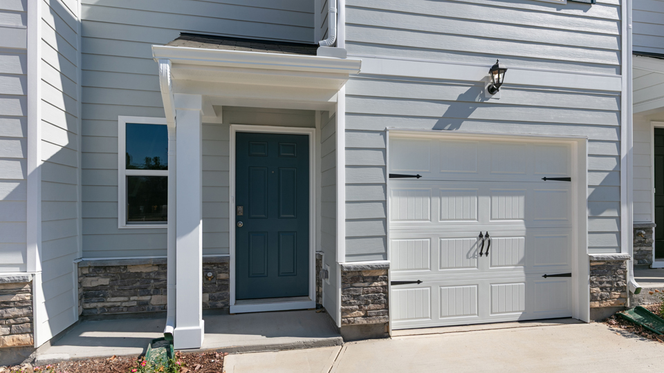front door of Pearson A3, blue, and car garage door, white, with covered space