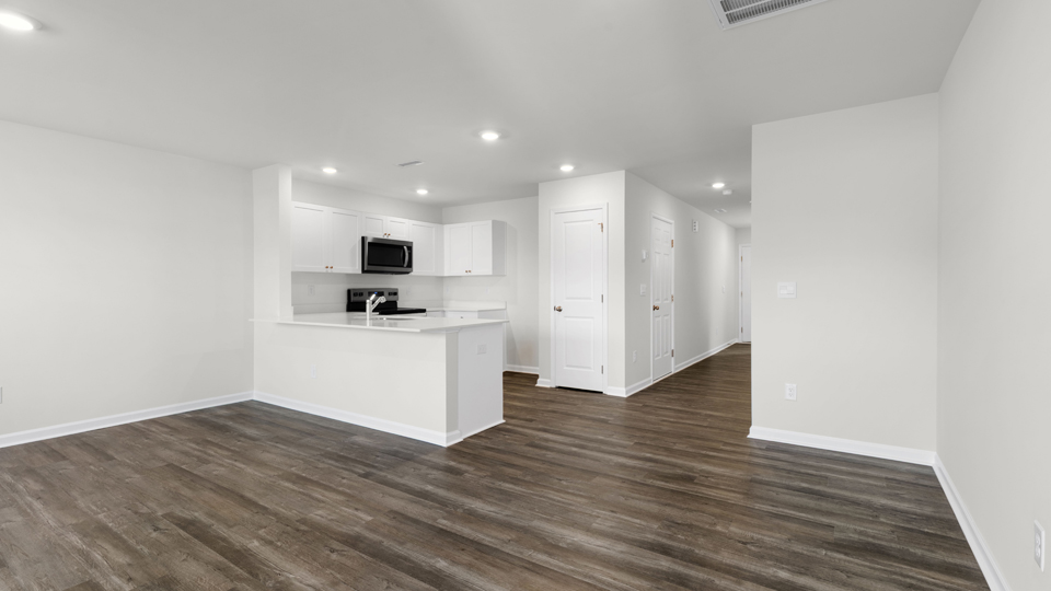 kitchen with quartz counters, kitchen island, pantry, stainless steel appliances