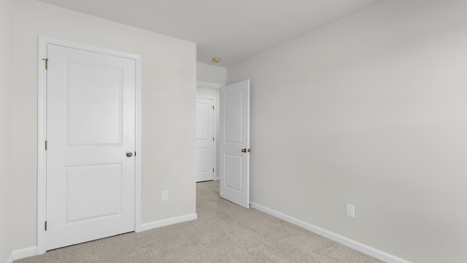 additional bedroom with window, carpeting, closet