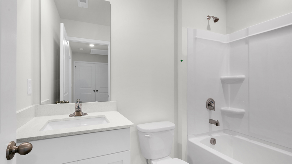 secondary bathroom with shower tub combo and single vanity sink