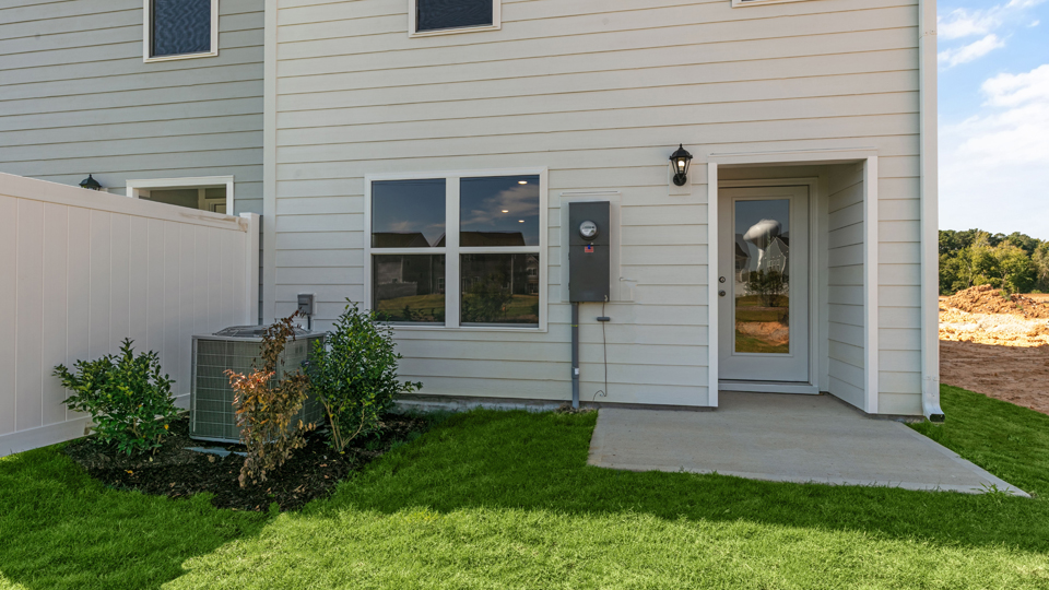 exterior patio with concrete slab and open yard