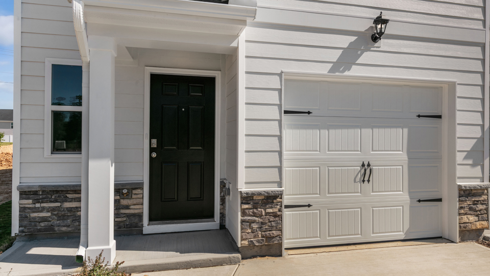 front door exterior, black door, white garage door