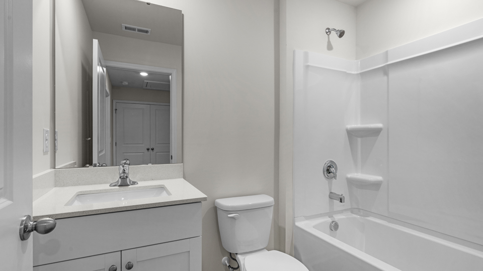 secondary bathroom with shower tub combo and single vanity sink