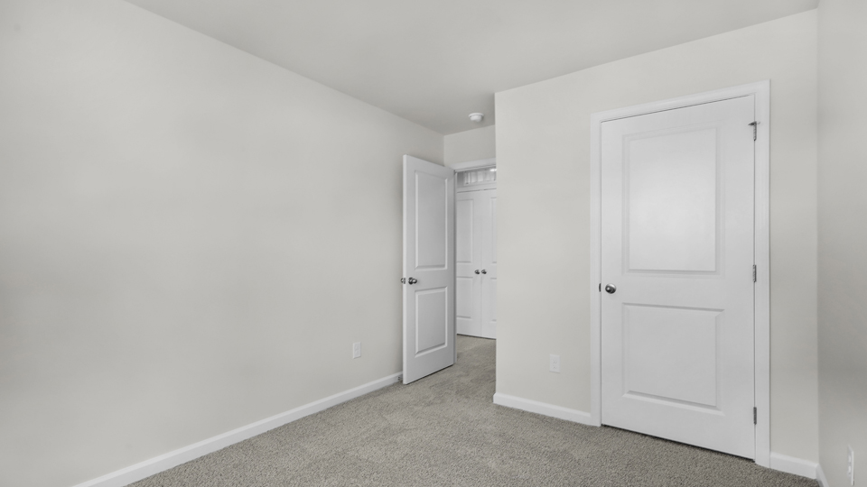 additional bedroom with window, carpeting, closet