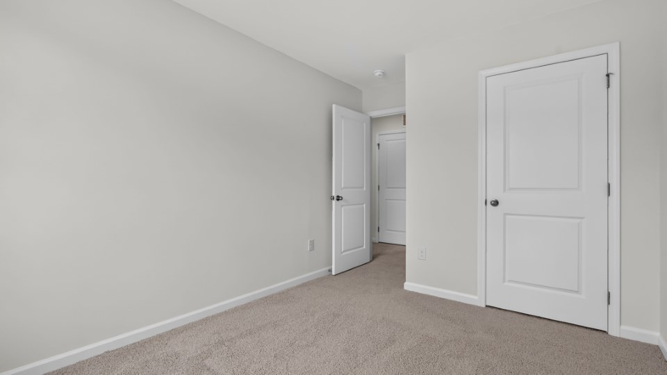additional bedroom with window, carpeting, closet