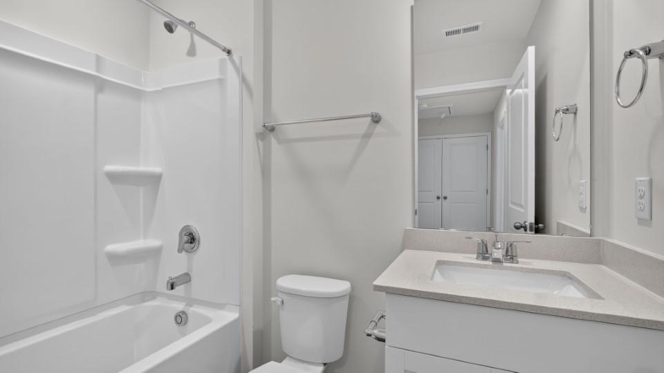 secondary bathroom with shower tub combo and single vanity sink