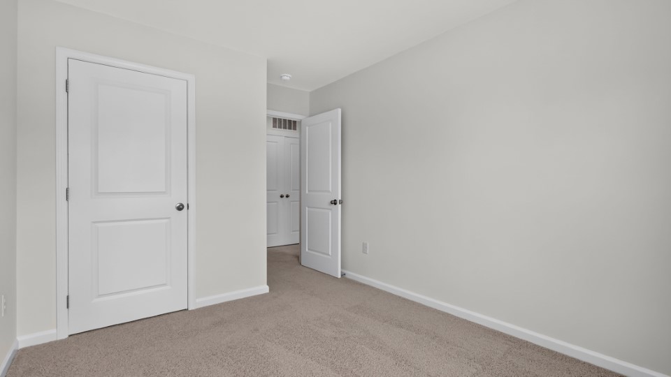 additional bedroom with window, carpeting, closet