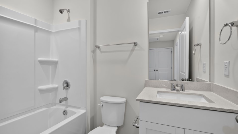 secondary bathroom with shower tub combo and single vanity sink