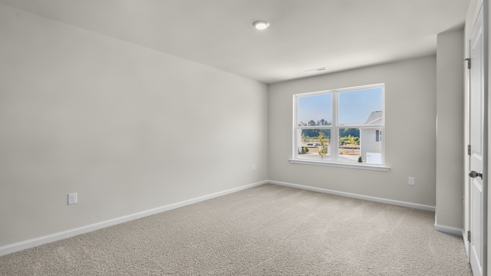 Primary bedroom with carpet flooring