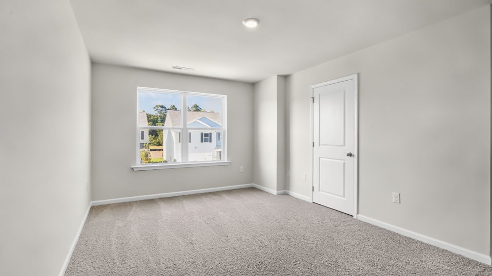 Primary bedroom with carpet flooring