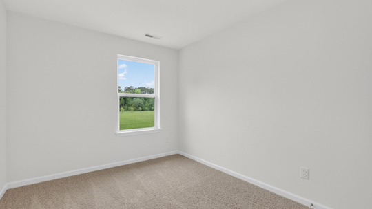 secondary bedroom with window and closet, carpeting