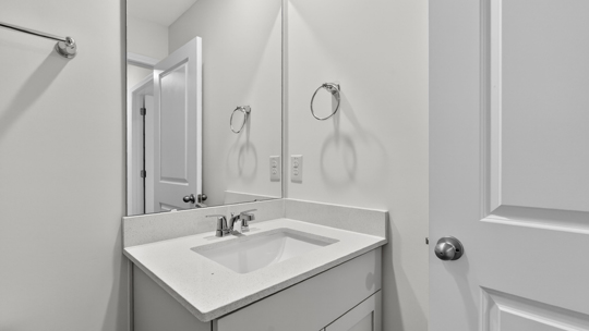 secondary bathroom with shower tub combo and single vanity sink