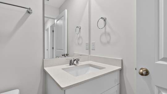 secondary bathroom with shower tub combo and single vanity sink
