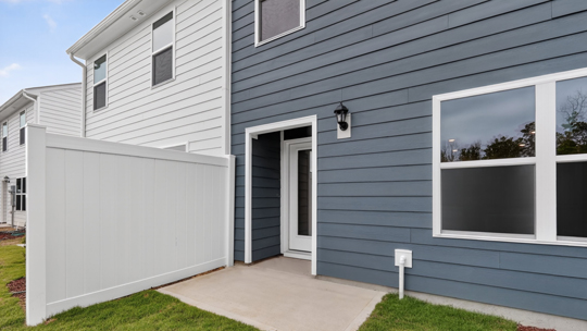 exterior patio with concrete slab and open yard