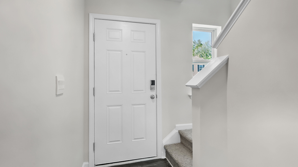 Entryway with white door