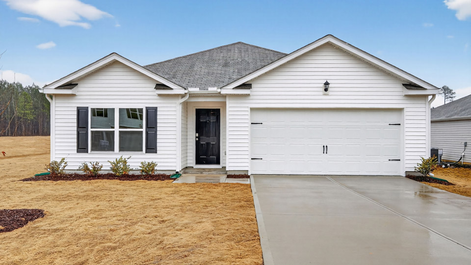 Single story home with white siding and a two-car garage.