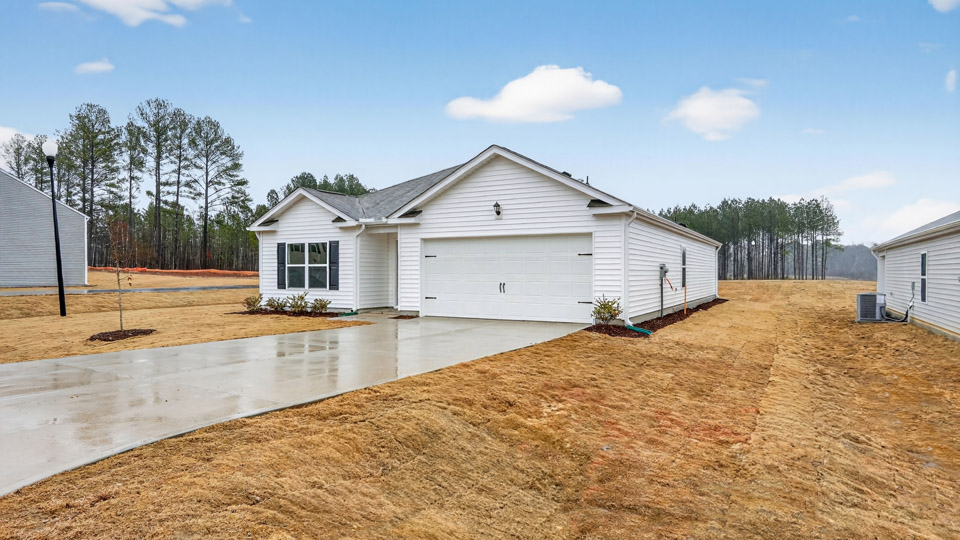 Single story home with white siding and a two-car garage.
