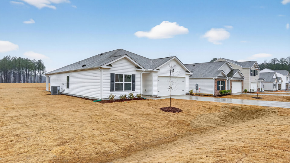 Single story home with white siding and a two-car garage.