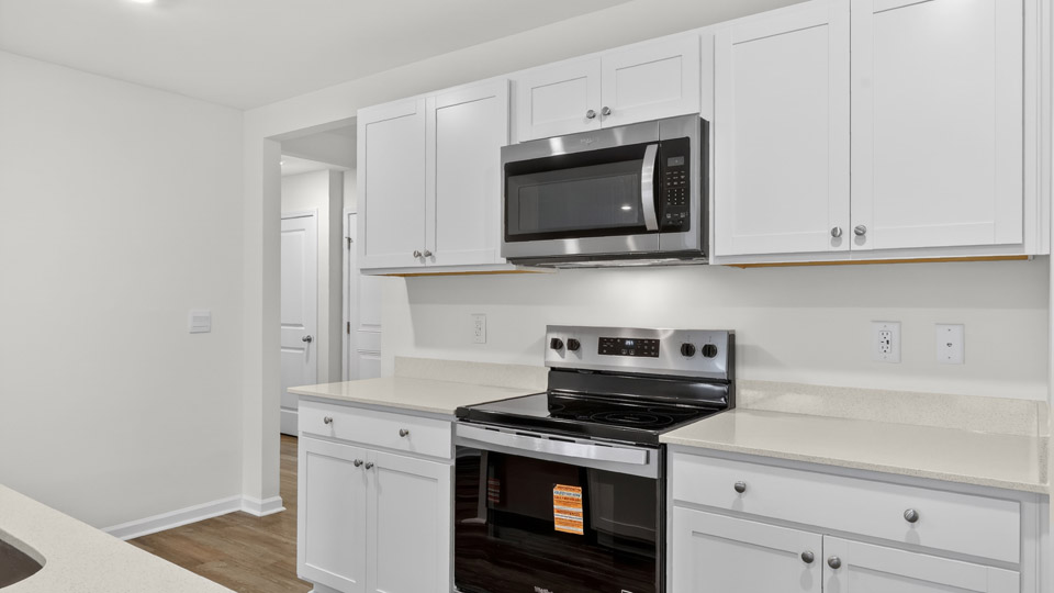 Kitchen with white cabinets and stainless steel appliances.