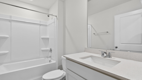 bathroom with tub shower combo and quartz countertops