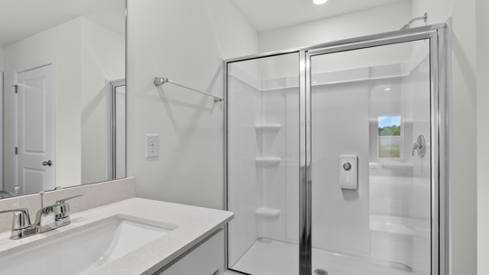 bathroom with quartz countertops and walkin glass door shower