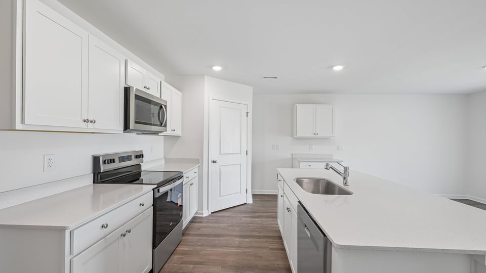 kitchen with quartz countertops white cabinets and spacious island