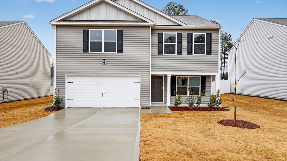 Two story home with gray colored siding with a two car garage