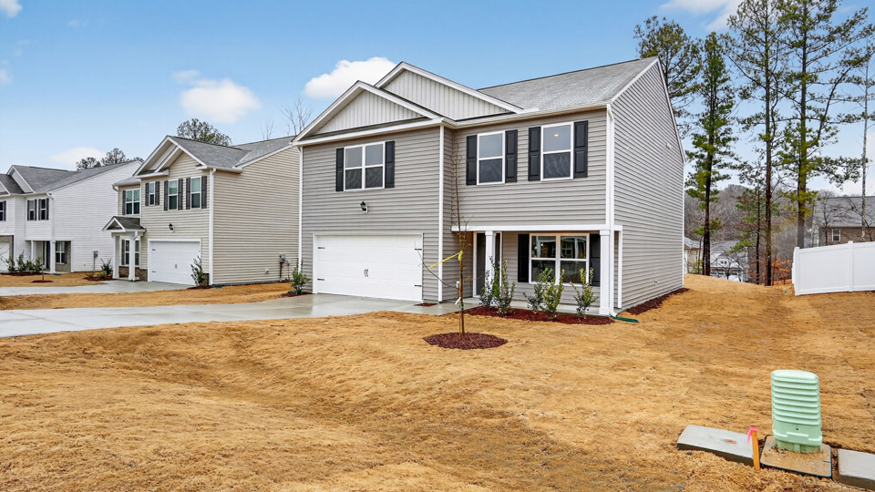 Two story home with gray colored siding with a two car garage
