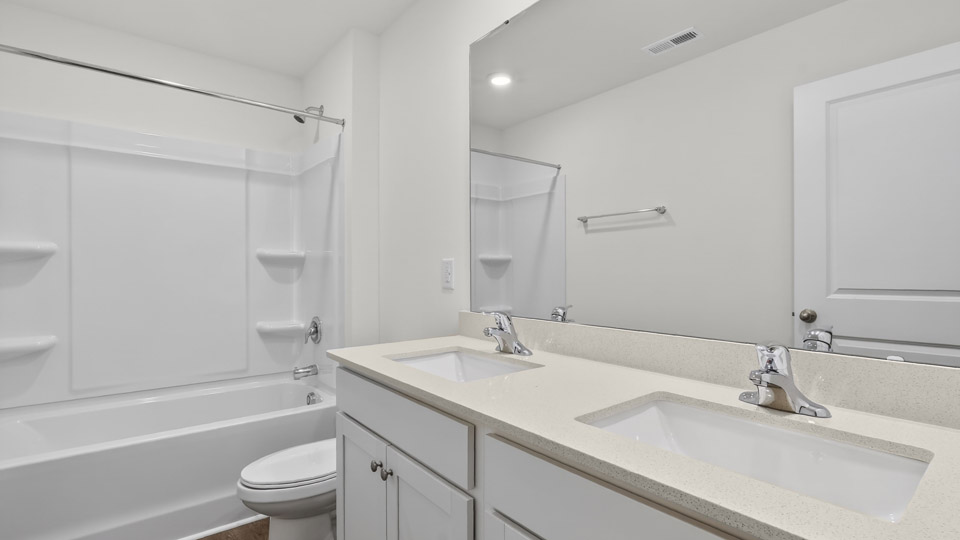 Bathroom with double sink and tub