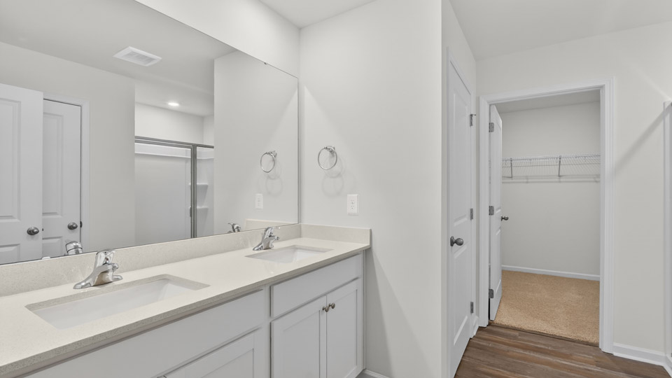 Primary bathroom with double sink and walk-in shower