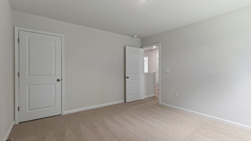 additional bedroom with window, carpeting, closet