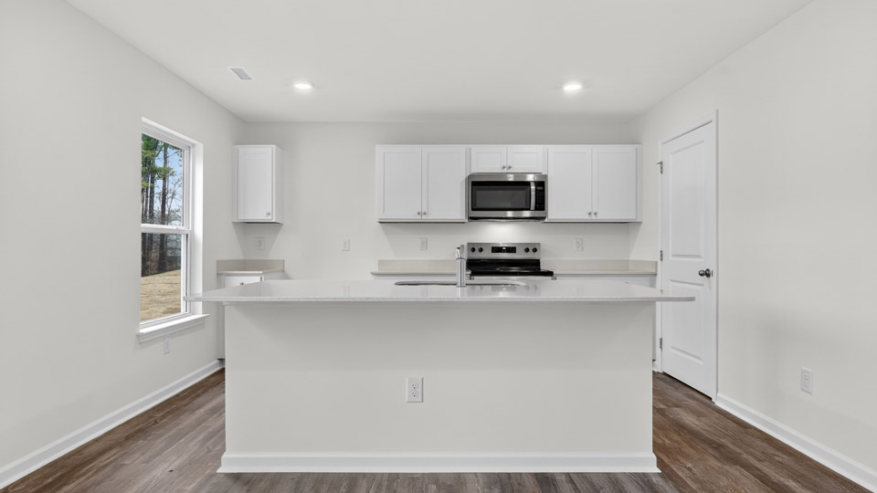 Kitchen with white cabinets and stainless steel appliances.