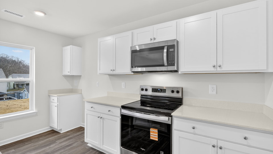 Kitchen with white cabinets and stainless steel appliances.