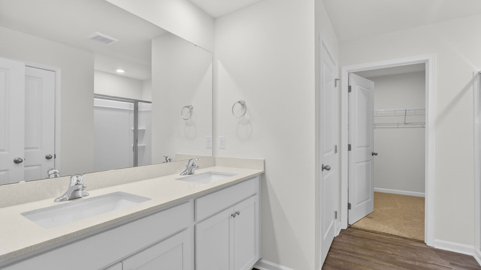 Primary bathroom with double sink and walk-in shower