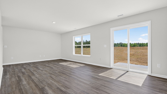 dining area with revwood flooring and sliding glass doors to patio