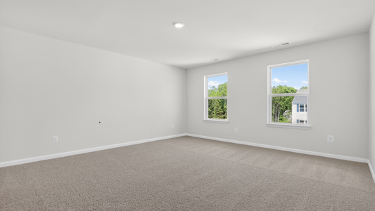 primary bedroom with carpet flooring