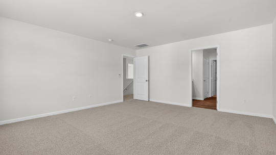 primary bedroom with carpet flooring
